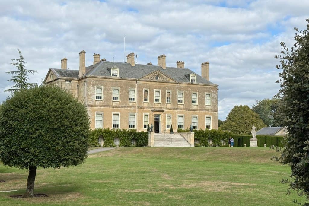 The front of Buscot Mansion - a Cotswold stone 18th Century house set in green grounds