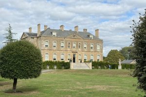 The front of Buscot Mansion - a Cotswold stone 18th Century house set in green grounds